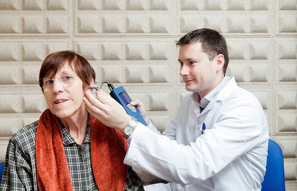Woman receiving tinnitus wax test