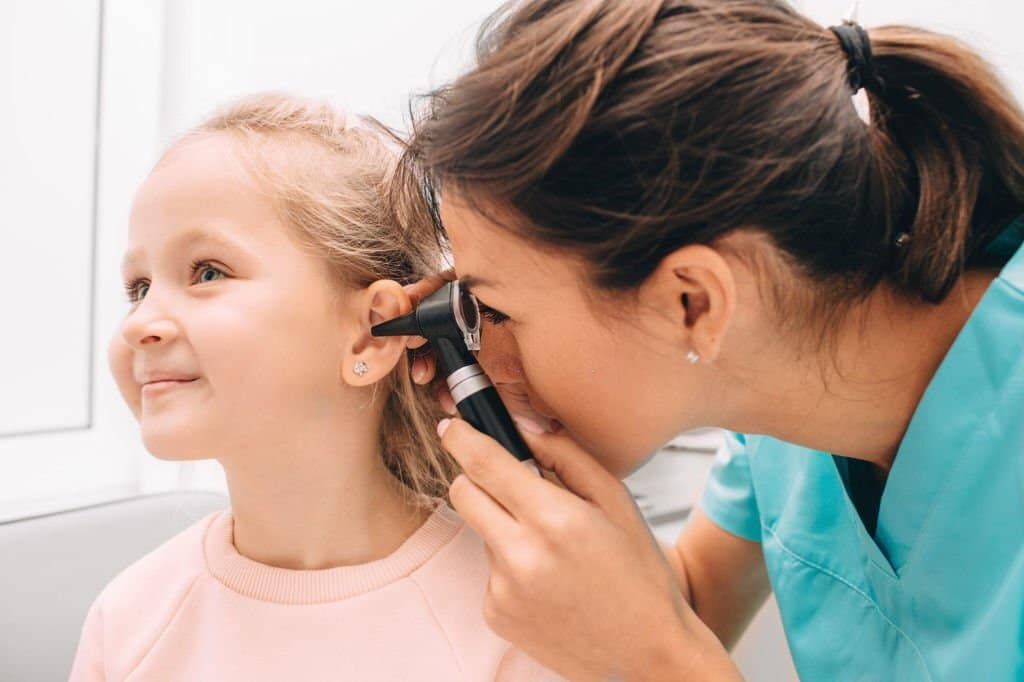 Audiologist Conducting Hearing Test of Kid