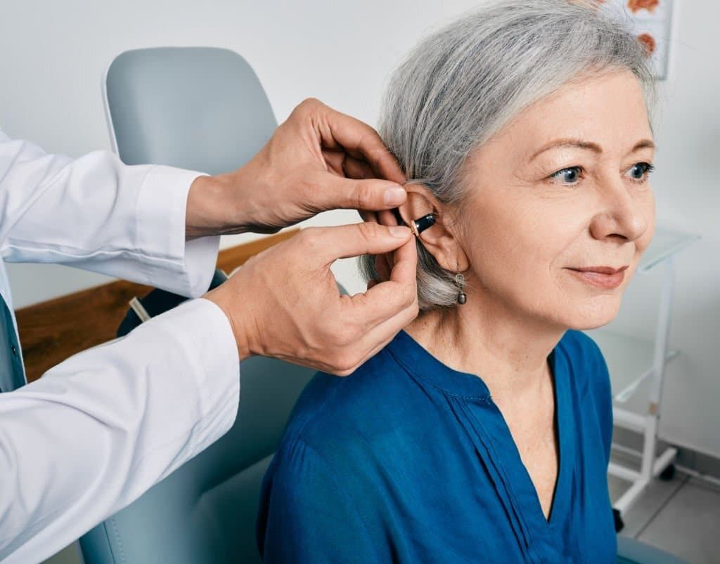 Woman Getting Hearing Aid Fitted
